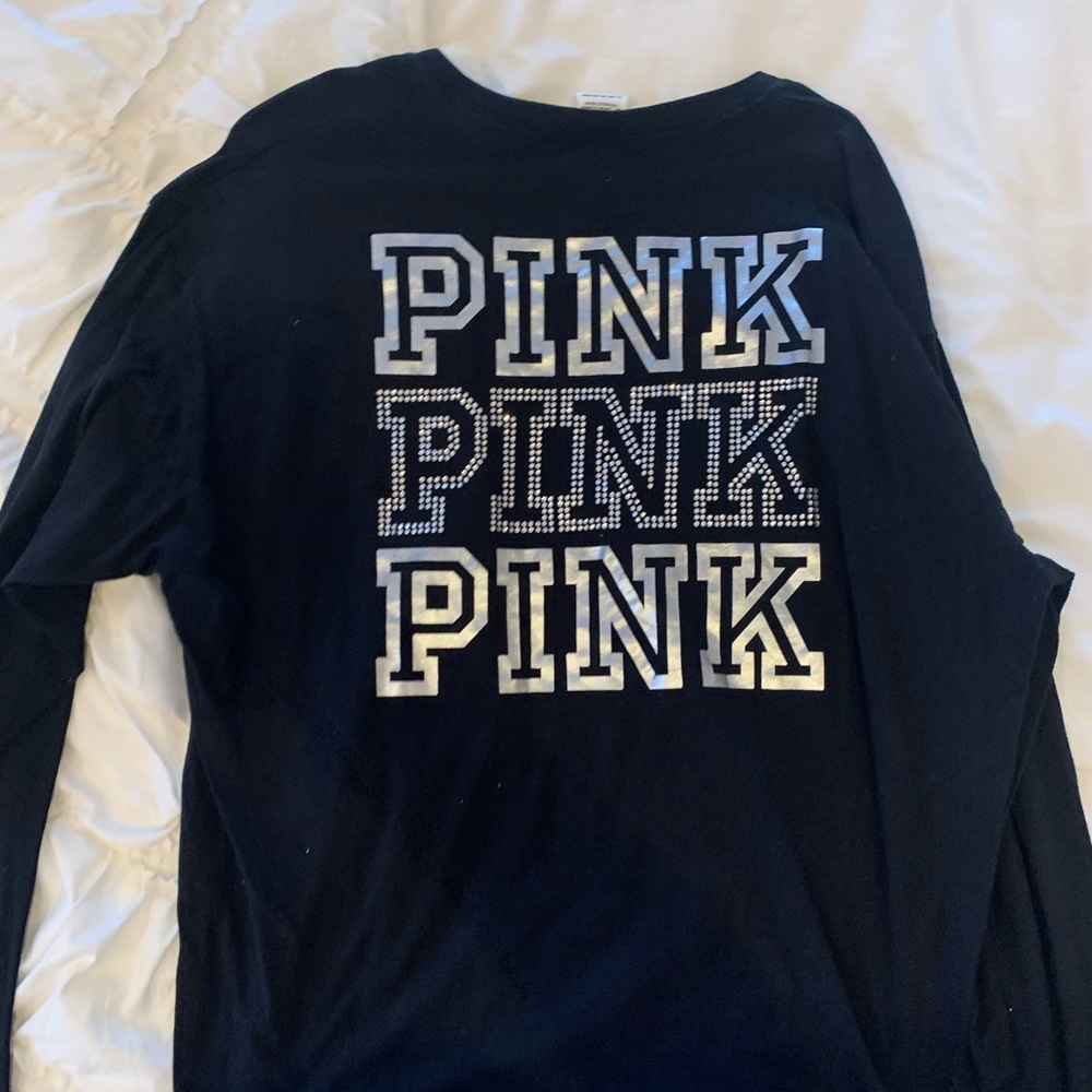 Pink shirt with sparkles on back rip higher on one side